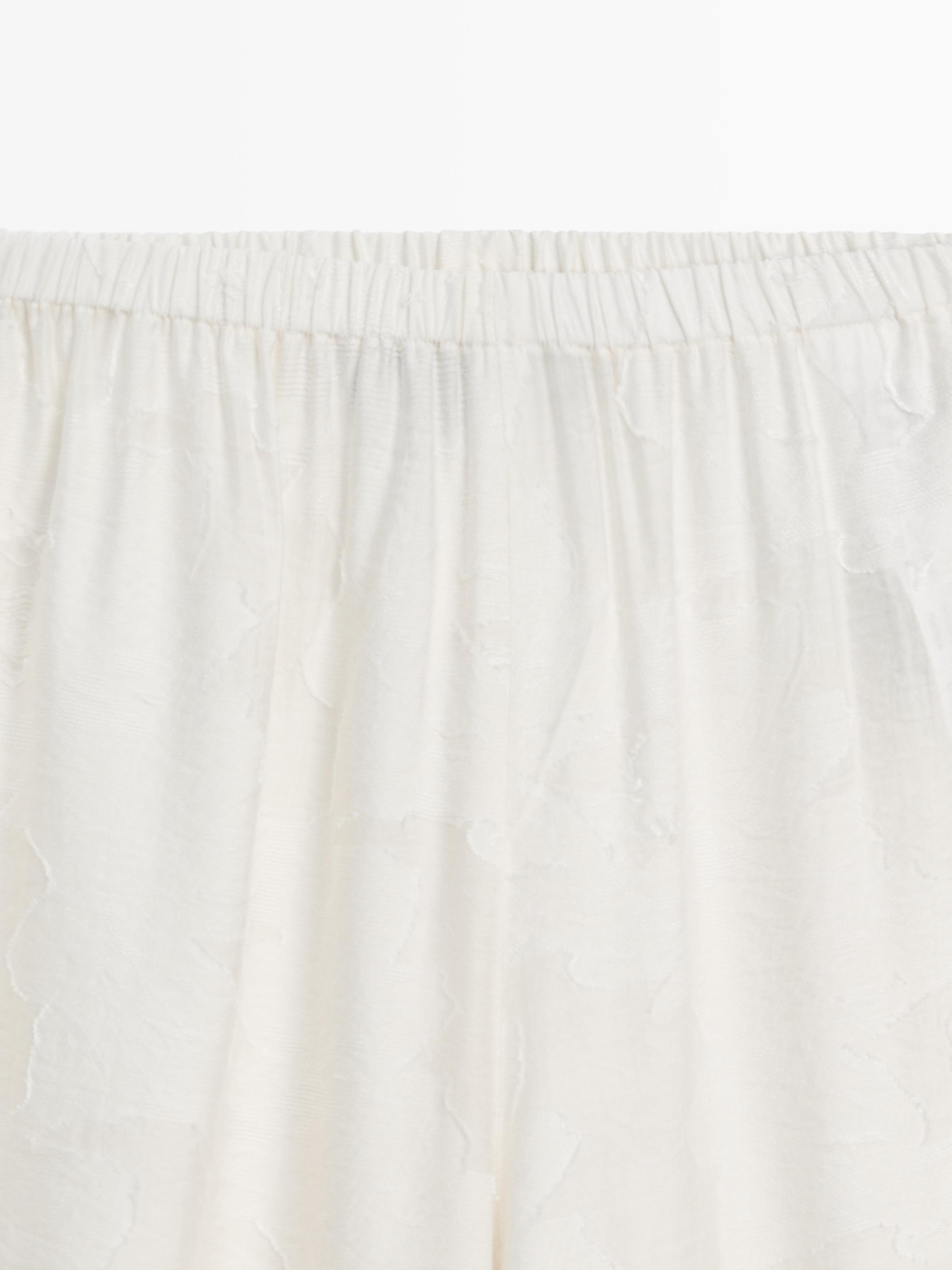 Flowing stretch trousers with fabric detail